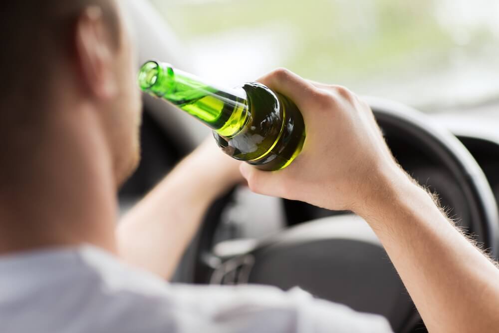 man drinking and driving