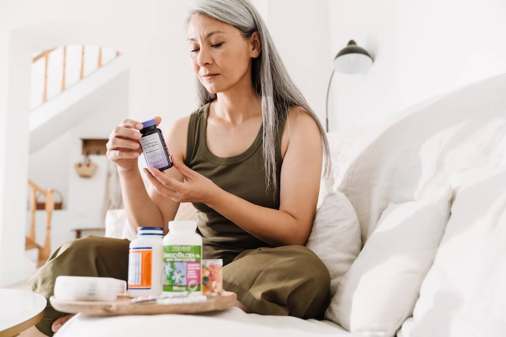 Woman looking at mental health medication bottle