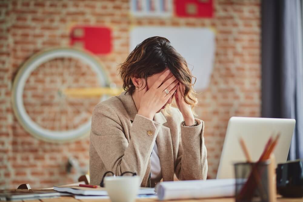 Woman looking depressed at her workplace
